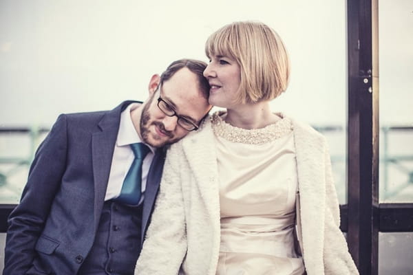 Groom resting head on bride's shoulder