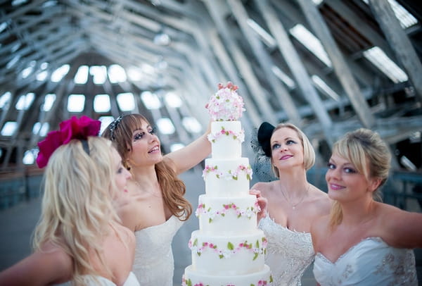 Brides looking at wedding cake