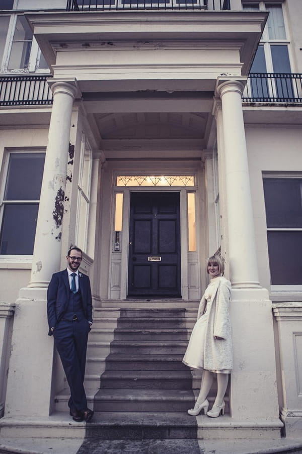 Bride and groom standing in front of steps