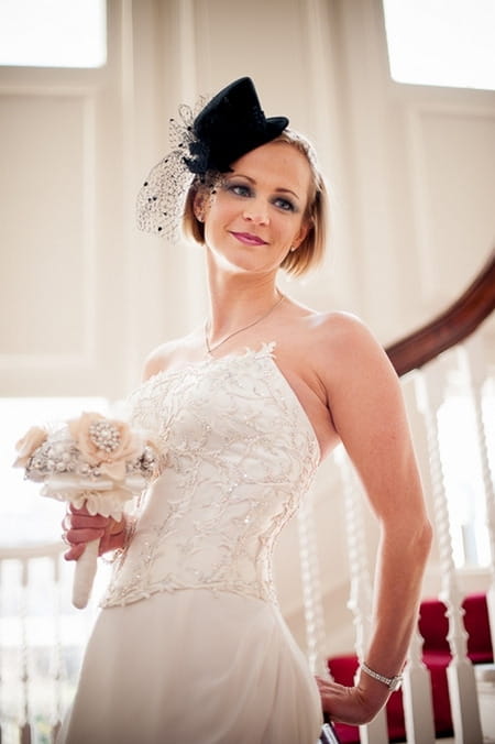 Bride with fascinator holding bouquet