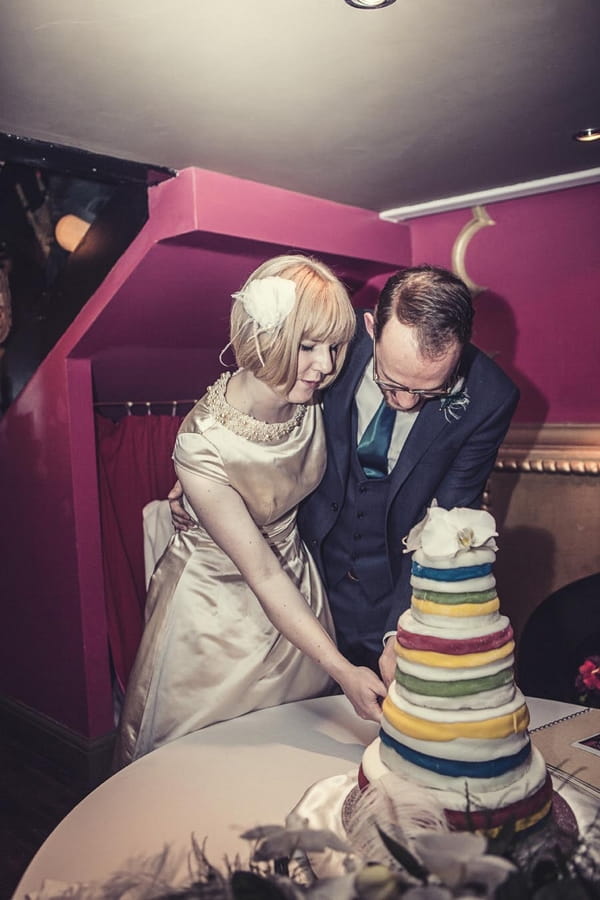 Bride and groom cutting wedding cake