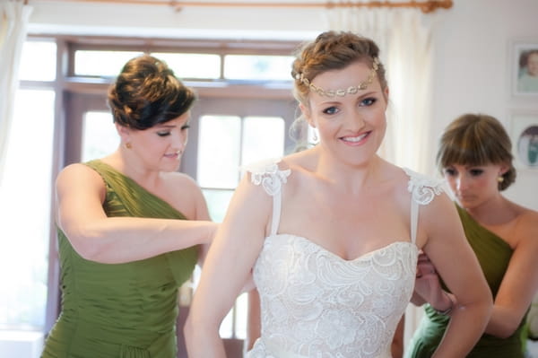 Bride being helped with her dress