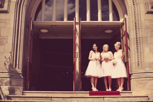 Bridesmaids standing on steps