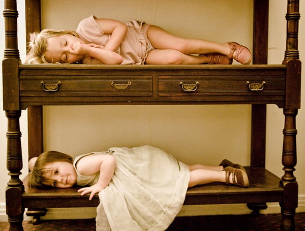 Young children laying down on cabineter - Picture by Kristian Leven Photography