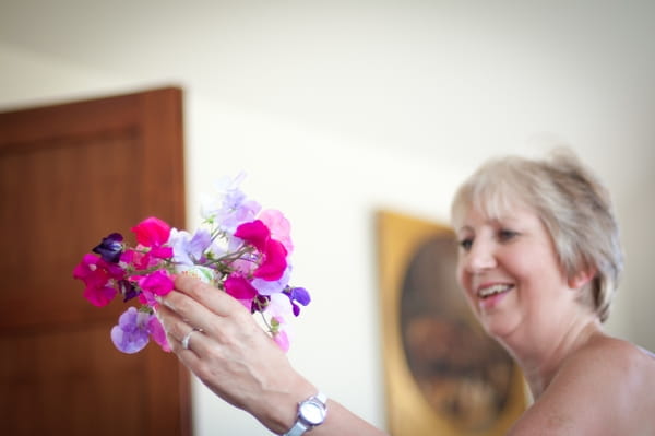 Woman holding colourful flowers