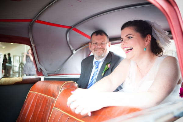 Bride in back of wedding car