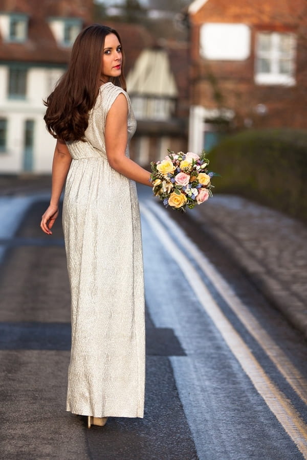 Bride in long dress walking down road