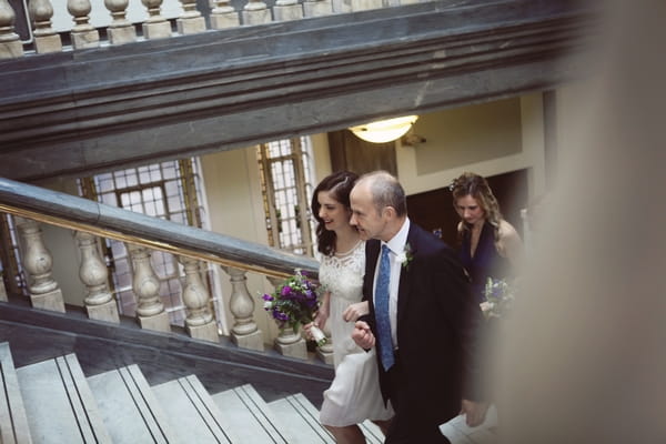 Bride and father walking up steps