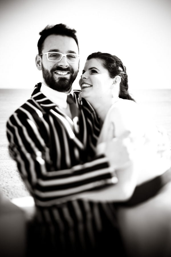 Bride with groom in striped jacket