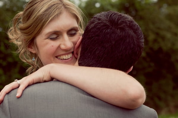 Bride hugging groom