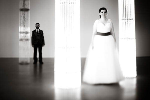 Bride in foreground, groom in background