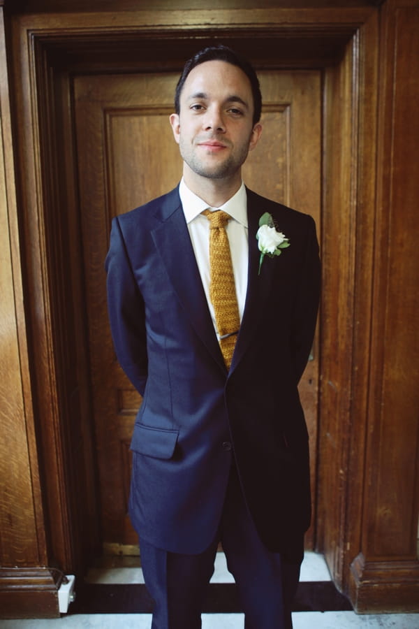 Groom in blue suit with knitted tie