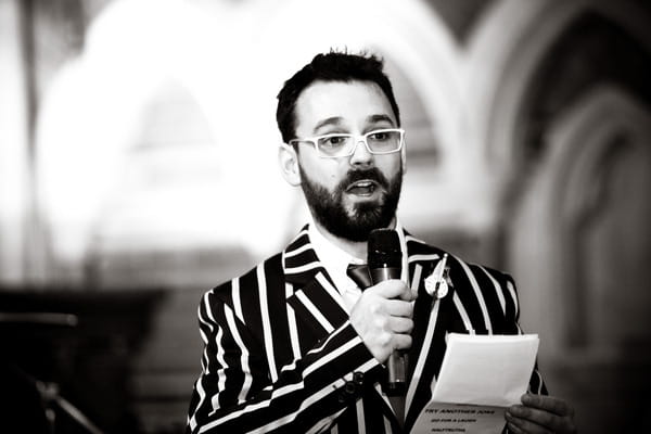 Groom in striped jacket giving wedding speech