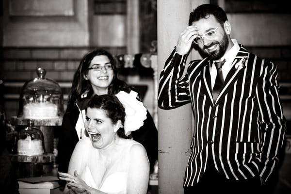 Bride and groom laughing at wedding speech