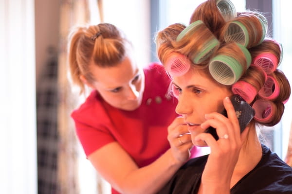 Bride with rollers in hair on the phone