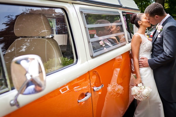 Bride and groom by orange camper van