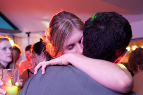 Bride and groom hug on dance floor