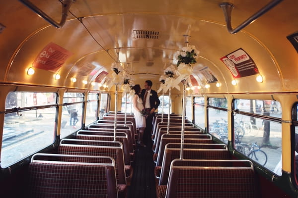 Bride and groom in aisle of bus