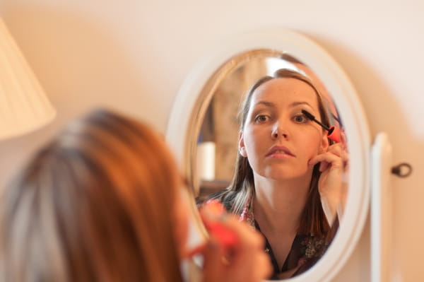 Bridesmaid applying mascara