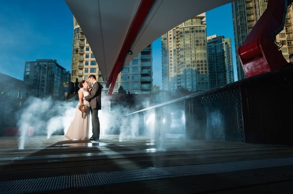 Bride and groom in vancouver by fountains