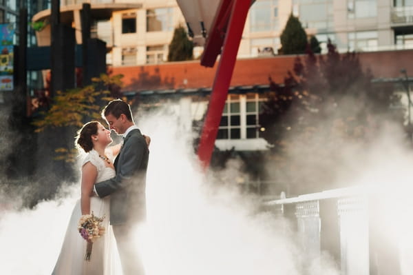 Bride and groom surrounded by smoke