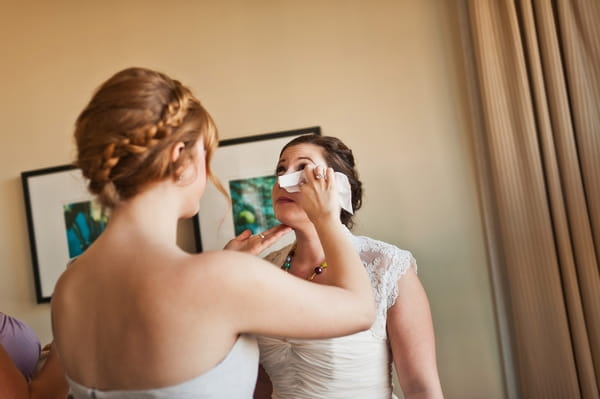 Bridesmaid wiping away bride's tear