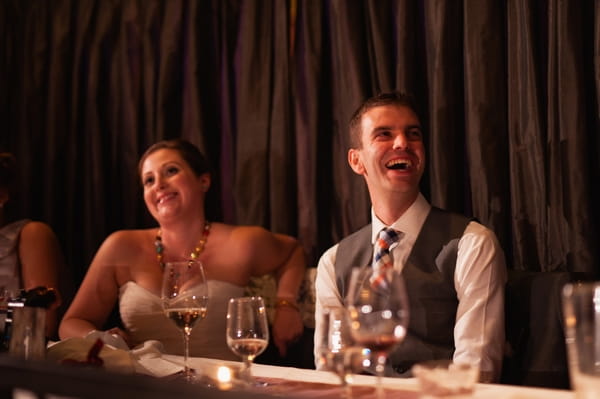 Groom laughing at speech