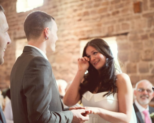 Bride wiping away tear