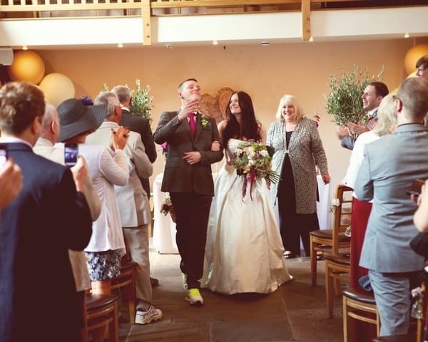 Bride and groom leaving wedding ceremony