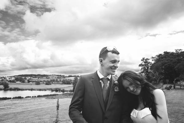 Bride resting head on groom's arm