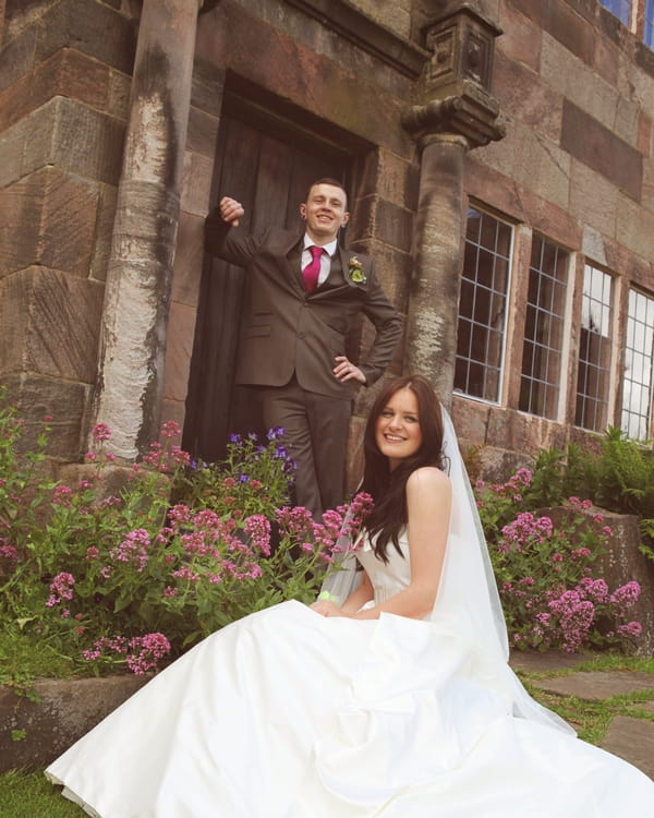 Bride and groom in front of old building