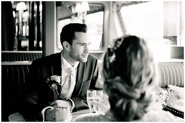 Groom looking out of boat window