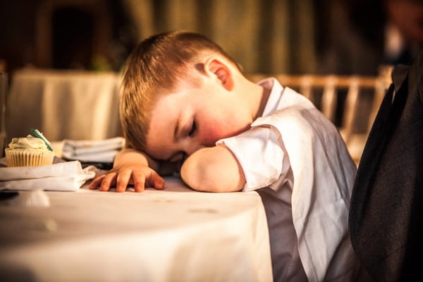 Pageboy asleep at table