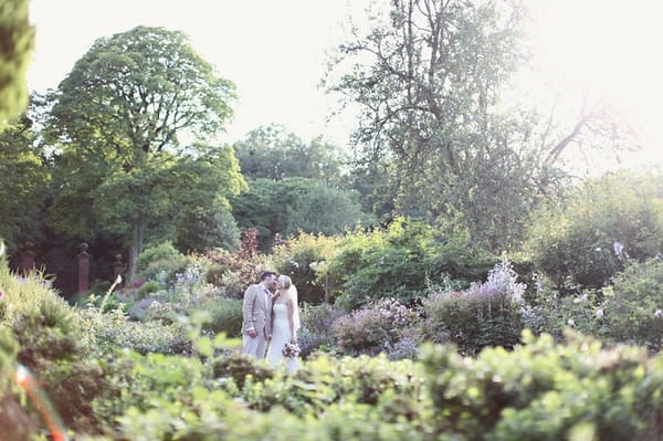 Bride and groom in Kirknewton Stables' gardens