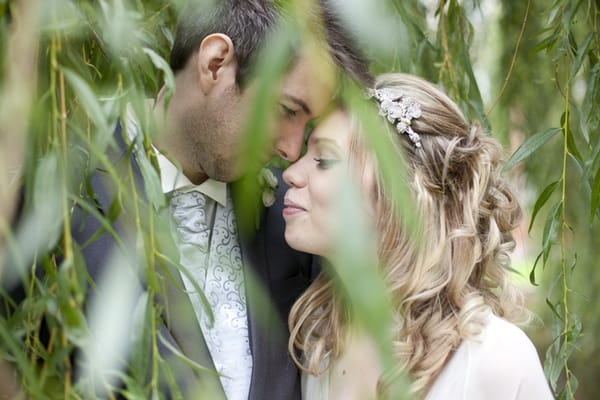 Picture of bride and groom taken though tree branches - Picture by Dan Hough Photography