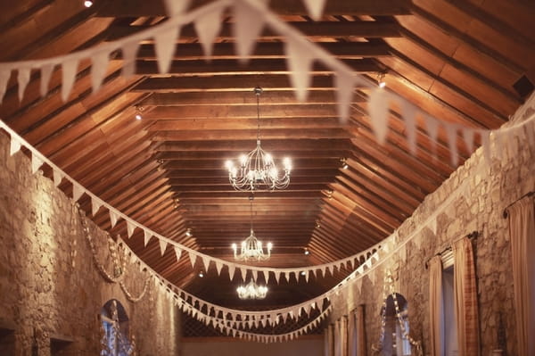 Bunting hanging from barn ceiling