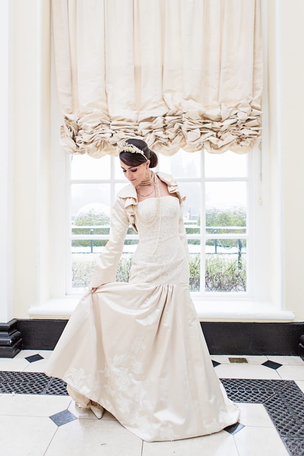 Bride holding up back of dress