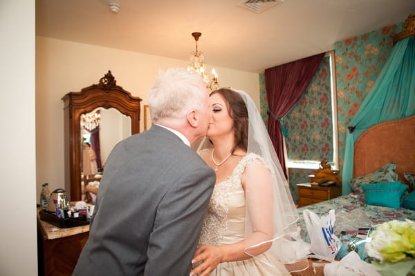 Father kisses daughter on wedding day