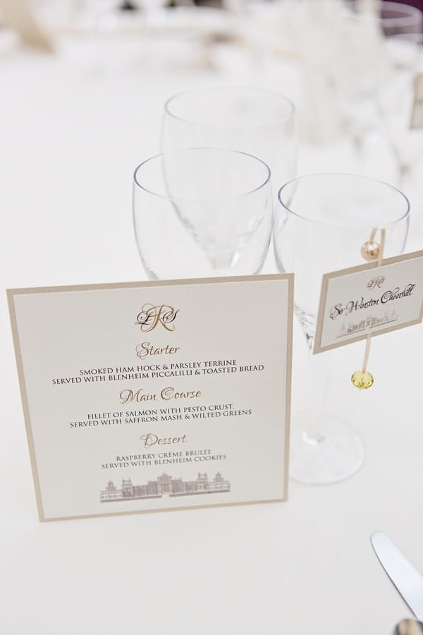 Wedding menu next to glass