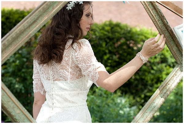 Bride walking past picture frame