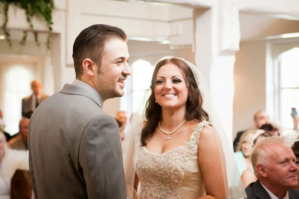Bride and groom smiling in wedding ceremony
