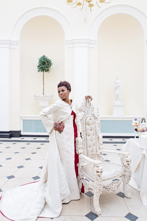 Bride standing next to chair