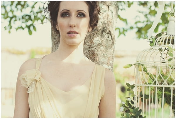 Bride standing by tree