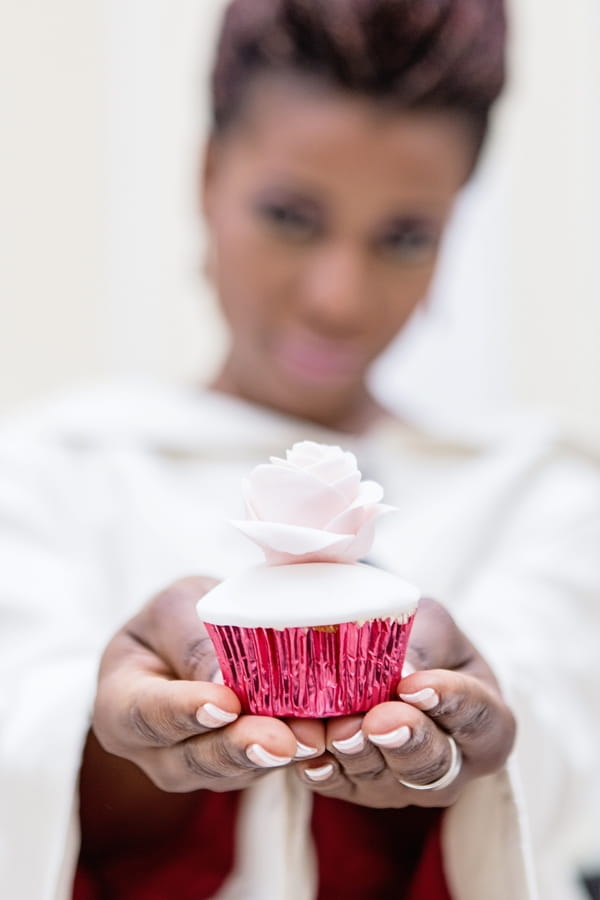 Bride holding out cupcake