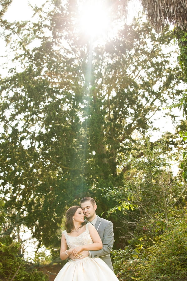Bride and groom in front of trees