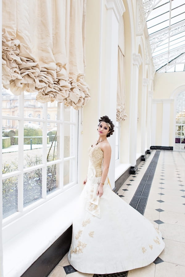 Bride standing by window