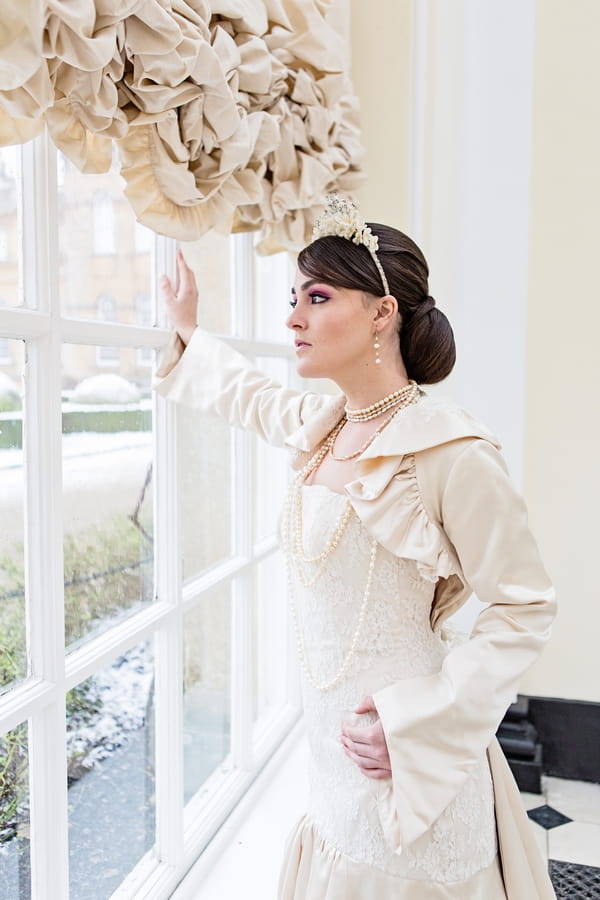 Bride leaning on window