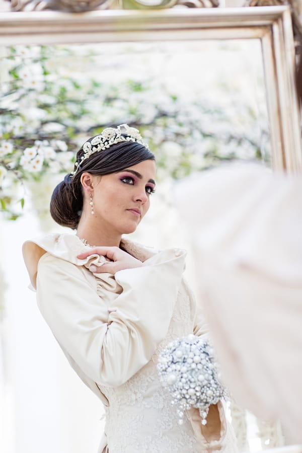 Bride looking in mirror