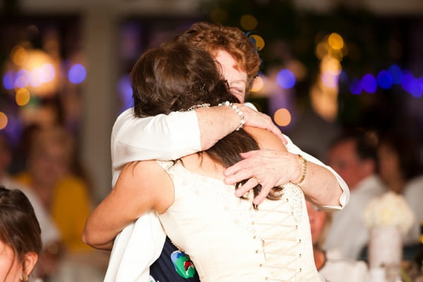 Bride hugging woman