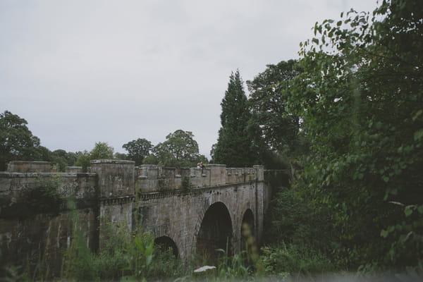 Bride and groom on bridge